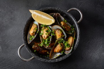 Classic French meal Moules marinière  Marinara mussels with garlic, sauce, lemon and parsley. 