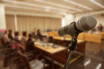 Blurred background Microphone in conference hall or seminar room with business people.