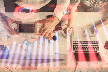 Double exposure of man and woman working together and financial chart hologram drawing. market analysis concept. Computer background. Top View.