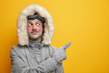 Pleased unshaven European man suggests to participate in ski racing competition wears grey...