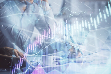 Double exposure of man and woman working together and financial graph hologram. Business concept. Computer background.