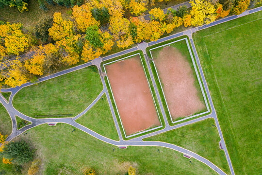 two public sports ground for soccer in colorful autumn park. top view aerial photo