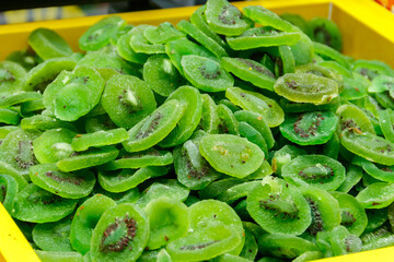 Candied fruit pieces of kiwi for sale in a market