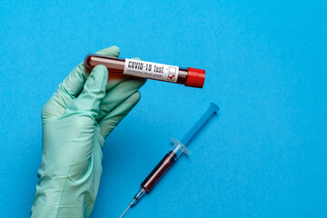 Fototapeta premium lab technician assistant or doctor holding a blood sample in test tube