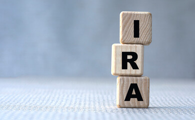 IRA word concept on wooden cubes on gray background