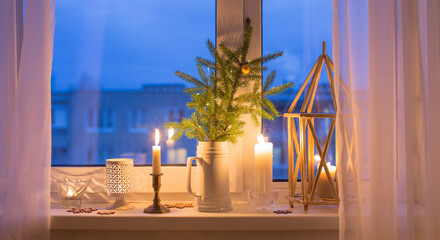 Christmas evening windowsill with burning candles