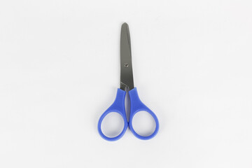 A blue used a scissor at the white background