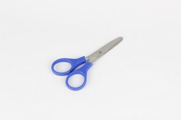 A blue used a scissor at the white background