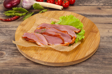Sliced smoked duck breast served salad
