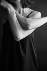 Obraz premium black and white natural portrait of a beautiful girl on a black background, minimalism and beauty of the female body