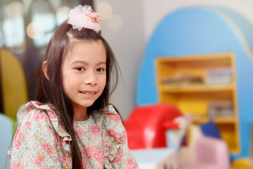 Portrait of smiling young beautiful girl at playground, kid having fun and playing with friend