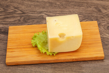 Emmental cheese over wooden board