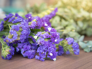 Fototapeta premium Purple satirist flowers on wooden table.