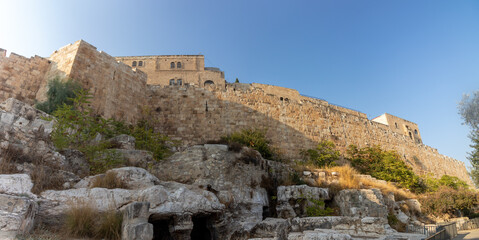 Fototapeta na wymiar jerusalem-israel. 30-10-2020. A panoramic view of the walls of the Old City and the Jewish Quarter, with two ancient caves in the foreground