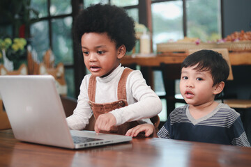 Two little boys with laptop computer, distance learning online education at home, new generation of goals for study technology education