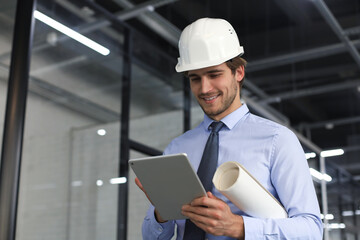 Shot of a engineer using a digital tablet on a construction site.