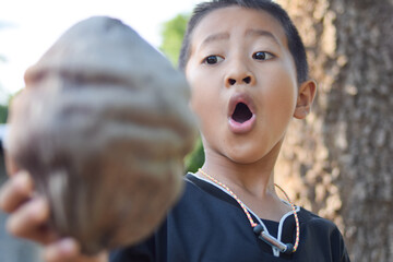 a boy exciting with dried coconut