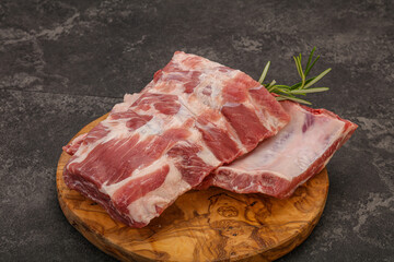 Raw pork ribs served rosemary