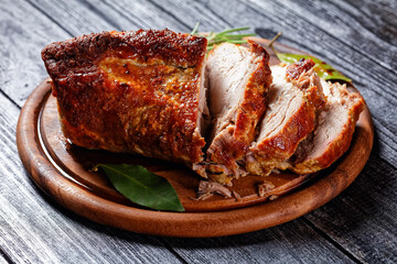 Roasted pork tenderloin on a wooden background