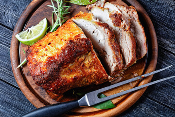 Roasted pork tenderloin on a wooden background