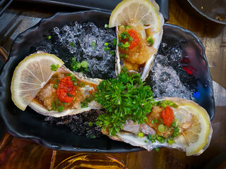 Fresh Oysters on ice with sauce ready to eat