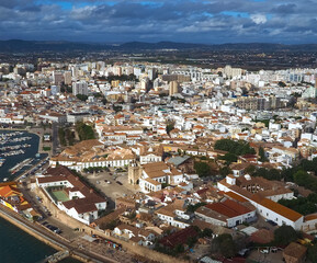 Fototapeta premium Aerial view of the city of Faro at the beautiful Algarve coast, in Portugal seen on a flight to Faro