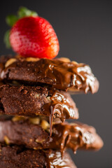 Stack of delicious chocolate cookies, food background.