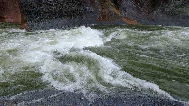 A slow motion of a water stream that flows noisily in a large rocky environment, Fukiware Falls, next to Numata, near Nikko National Park, Japan.