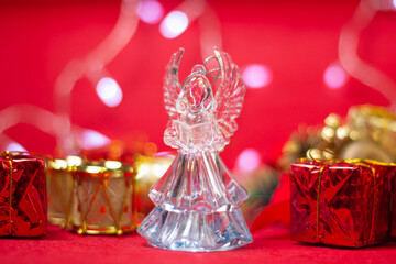 Christmas decorations on a red background. Holiday decorations. Glass angel on a Christmas background. Christmas concept