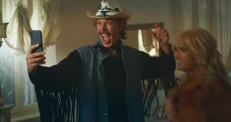 Cinematic shot of carefree happy smiling homosexual male gay and transgender woman couple in love is making a selfie or video technology call to relatives or friends with smartphone at home. - Powered by Adobe