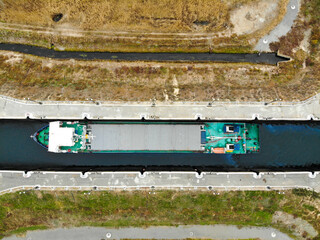 Obraz premium Cargo transportation by water transport. The dry cargo ship is in the lock chamber of the Volga-Don Shipping Canal. Volgograd. Russia.