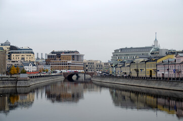 Moscow architecture in the city center. River, embankment, bridge, historical buildings.