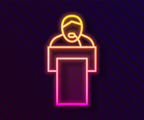 Glowing neon line Gives lecture icon isolated on black background. Stand near podium. Speak into microphone. The speaker lectures and gestures. Vector.