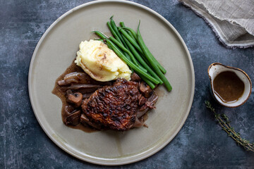 Cock au vin, French dish of chicken braised in wine with mashed potatoes and green beans