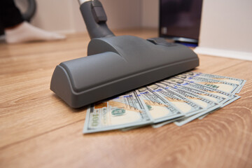 Vacuum cleaner suck usd dollar banknotes. Launder money concept