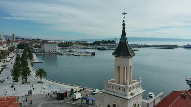 flying counter clockwise around church tower reveal of Riva in Split Croatia