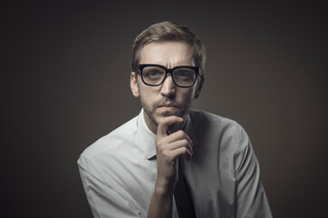 Pensive man with hand on chin