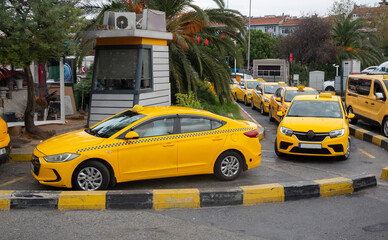 Vehicles waiting at the taxi stand front view.