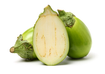 half and whole green eggplant on white background.