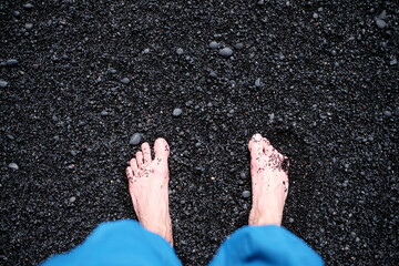 Feet on the black sand
