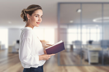 Young businesswoman with planner in office