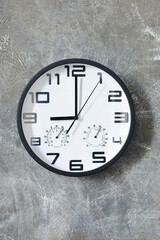 wall clock at concrete  or painted background