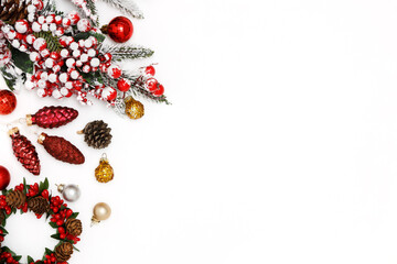 New Year's composition. Snowy spruce branches, red Christmas balls on a white background. Winter, new year concept. Flat lay, top view, copy space