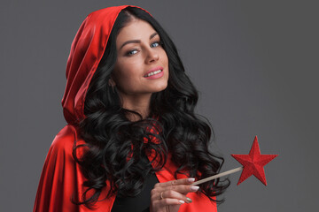 Woman in red cape with magic wand