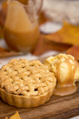 Autumn mini apple pie with lattice, ice cream, caramel sauce and leaves