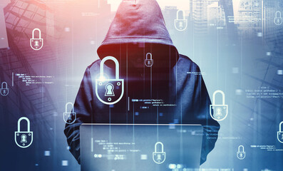 Hacker with laptop in city, cyber security