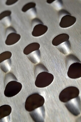 metal kitchen grater with large holes. macro.