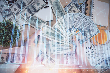 Multi exposure of financial graph drawing hologram and USA dollars bills and man hands. Analysis concept.