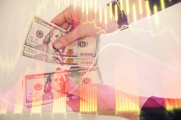 Multi exposure of financial graph drawing hologram and USA dollars bills and man hands. Analysis concept.
