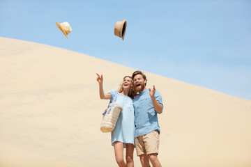 happy couple throwing the hats